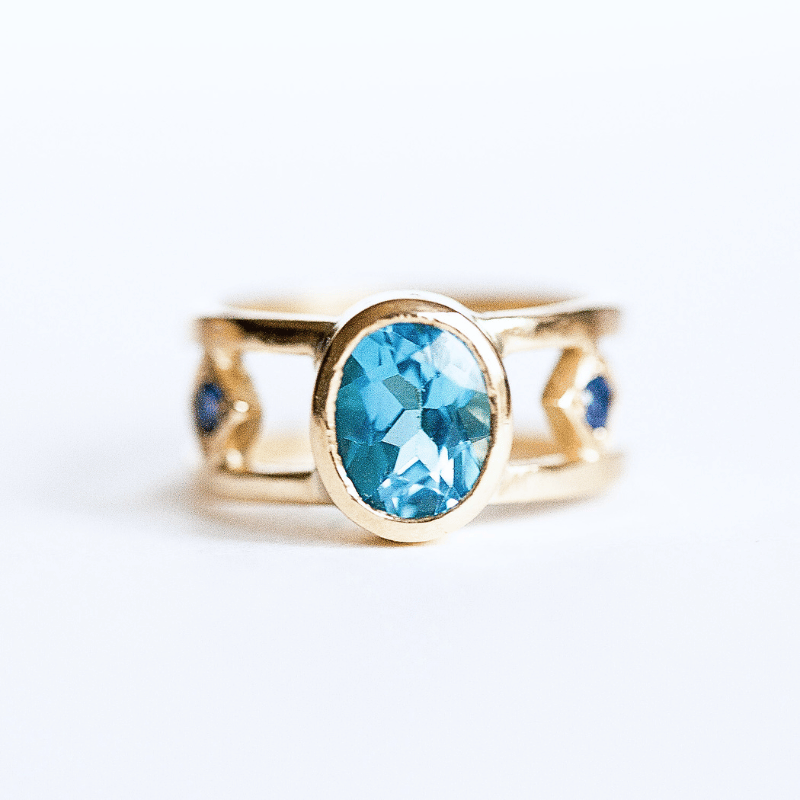 Blue topaz an gold dress ring
